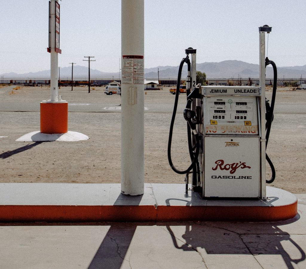 Photo of an old style gas station in the desert. 